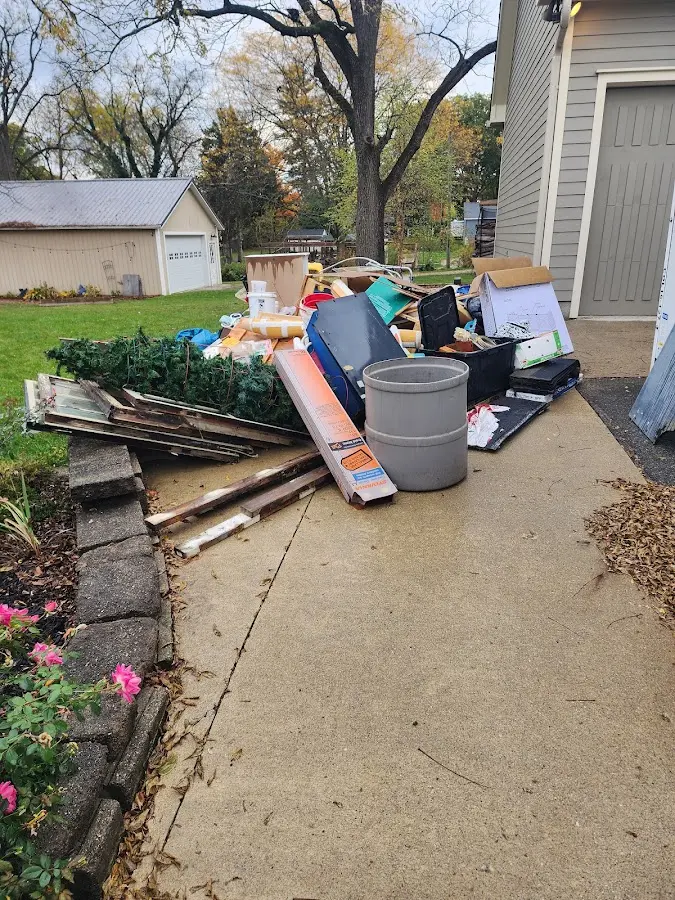 Dumpster being loaded with debris for Estate Cleanout Dumpster Rental in Claremont